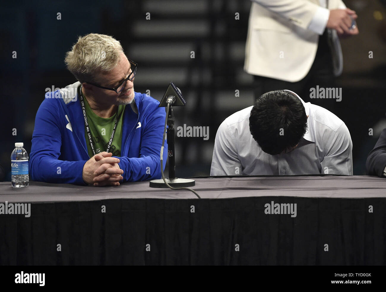 Manny Paciquiao, right, hangs his head as his trainer, Freddie Roach looks on during a news conference after his welterweight unification bout against Floyd Mayweather Jr. at MGM Grand Garden Arena Saturday, May 2, 2015, in Las Vegas, Nevada. Mayweather won with an unanimous decision after the 12 round fight. Photo by David Becker/UPI Stock Photo