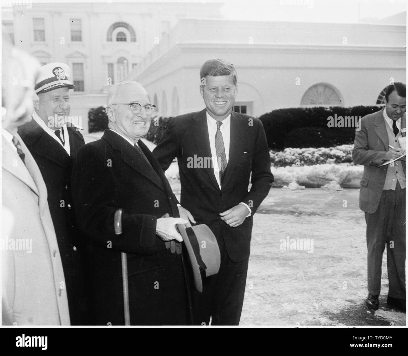 Photograph of President John F. Kennedy, on his first full day in office, greeting former President Harry S. Truman, who is visiting the White House for the first time since he left the Presidency in 1953. Stock Photo