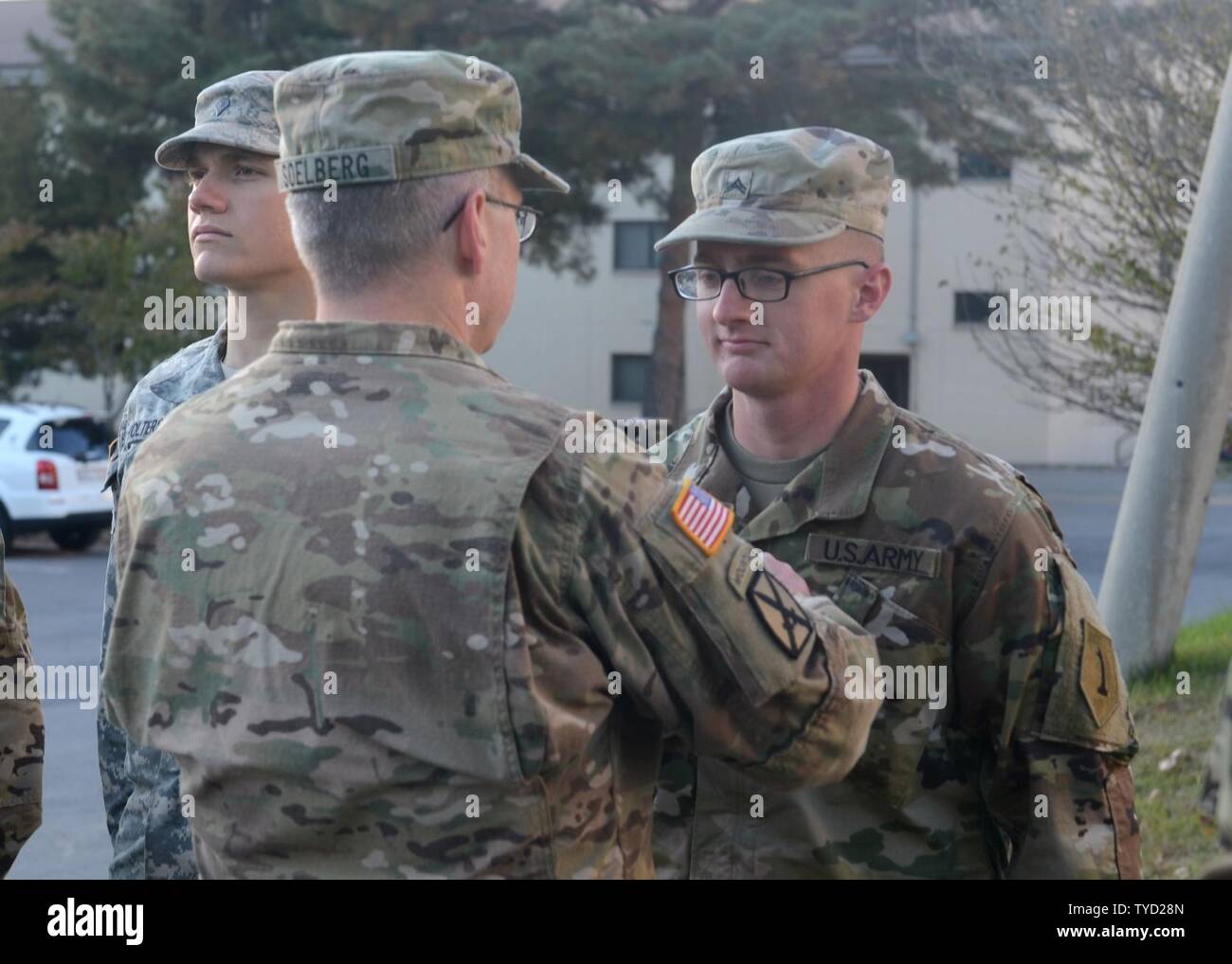 CAMP CASEY, Republic of Korea – Maj. Brent Soelberg (left), the automations management officer for the 2nd Infantry Division, pins the rank of sergeant onto his son, Sgt. Austin Soelberg, a tank crewmember with 2nd Battalion, 34th Armor Regiment, 1st Armored Brigade Combat Team, 1st Inf. Div., during a promotion ceremony Nov. 1.  The Soelbergs, both from Ogden, Utah, are both currently serving in different units on the Korean peninsula, making the promotion ceremony a unique opportunity for both Soldiers. Stock Photo