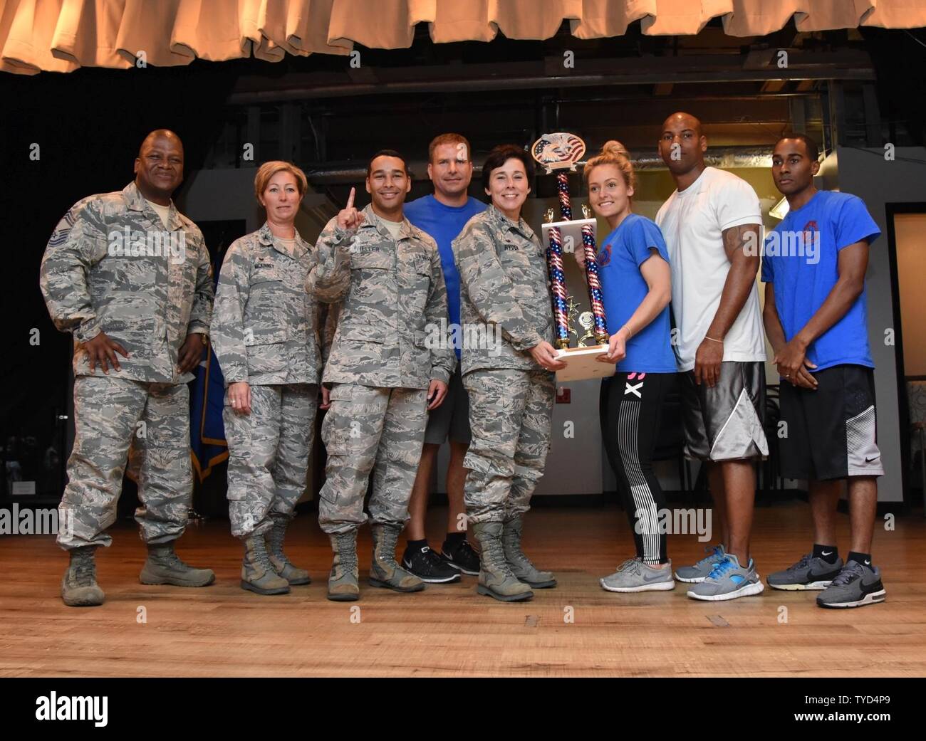 Members of the 81st Dental Squadron are presented the first place trophy by Col. Jeannine Ryder, 81st Medical Group commander, during the 81st MDG Push-up Competition at the Keesler Medical Center Don Wylie Auditorium Nov. 1, 2016, on Keesler Air Force Base, Miss. Seven five-person teams competed in the event pushing out a total of 6,272 push-ups. The 81st Dental Squadron accumulated 1,127 push-ups. The Airmen who participated in the event raised money to support the Krewe of Medics Mardi Gras Ball. Stock Photo