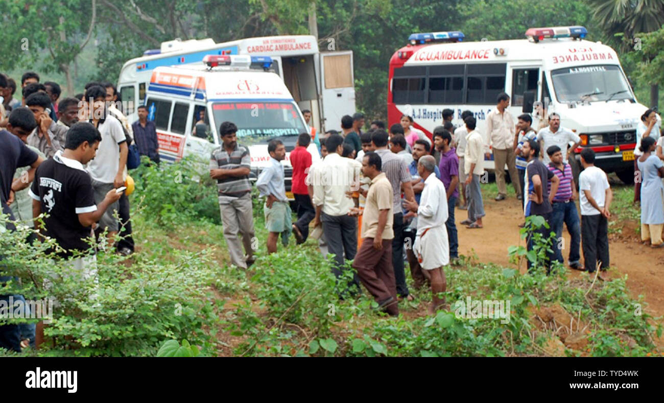 Ambulances and people gather near the site Air India Express plane after it overshot the runway and crashed at Bajpe Airport in Mangalore, India on May 22, 2010. Of the 166 passengers and crew on board the plane, only 8 survived. UPI Stock Photo