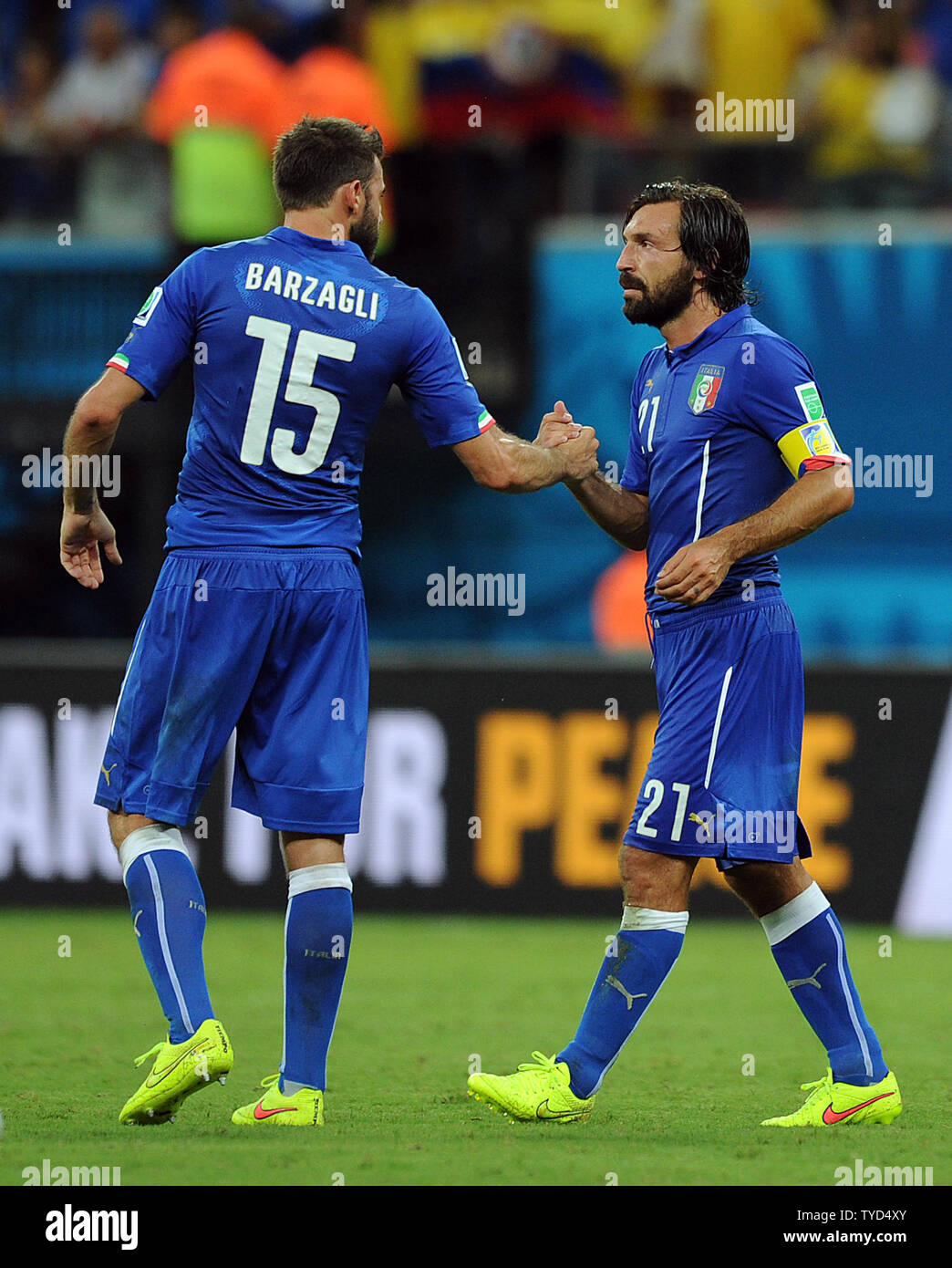 Andrea Pirlo of Italy is congratulated by team-mate Andrea Barzagli at full-time following the 2014 FIFA World Cup Group D match at the Arena Amazonia in Manaus, Brazil on June 14, 2014. UPI/Chris Brunskill Stock Photo