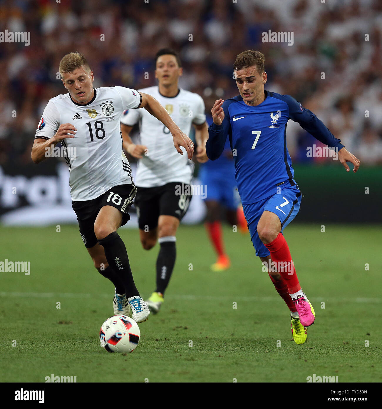 Toni Kroos (L) of Germany chases Antoine Griezmann of France during the  Euro 2016 Semi-Final match at the Stade Velodrome in Marseille, France on  July 7, 2016. France beat Germany 2-0 to