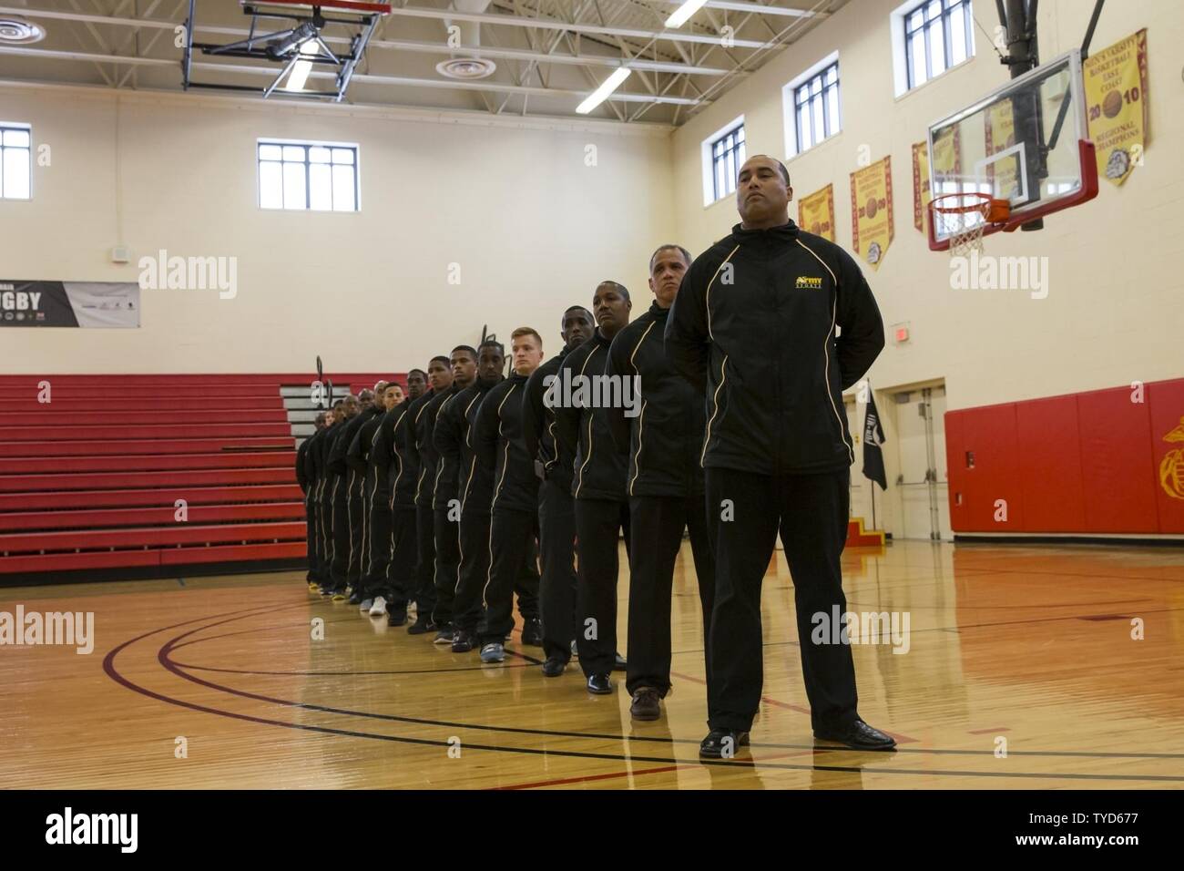 U.S. military members of the All Army basketball team stand in
