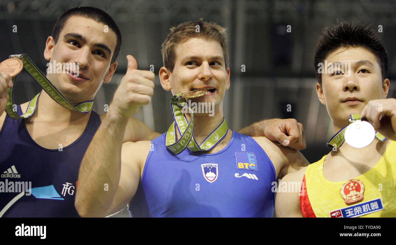 Medalists in the men's vault finals brandish their medals at the Rod Laver Arena for the World Artistic Gymnastics Championships in Melbourne, Australia on November 27, 2005. From left: Yann Cucherat of France (bronze, 9.662 points), Mitja Petkovsek of Slovenia (gold, 9.700 points), and Xiaopeng Li of China (silver, 9.9.675 points).  (UPI Photo / Grace Chiu) Stock Photo