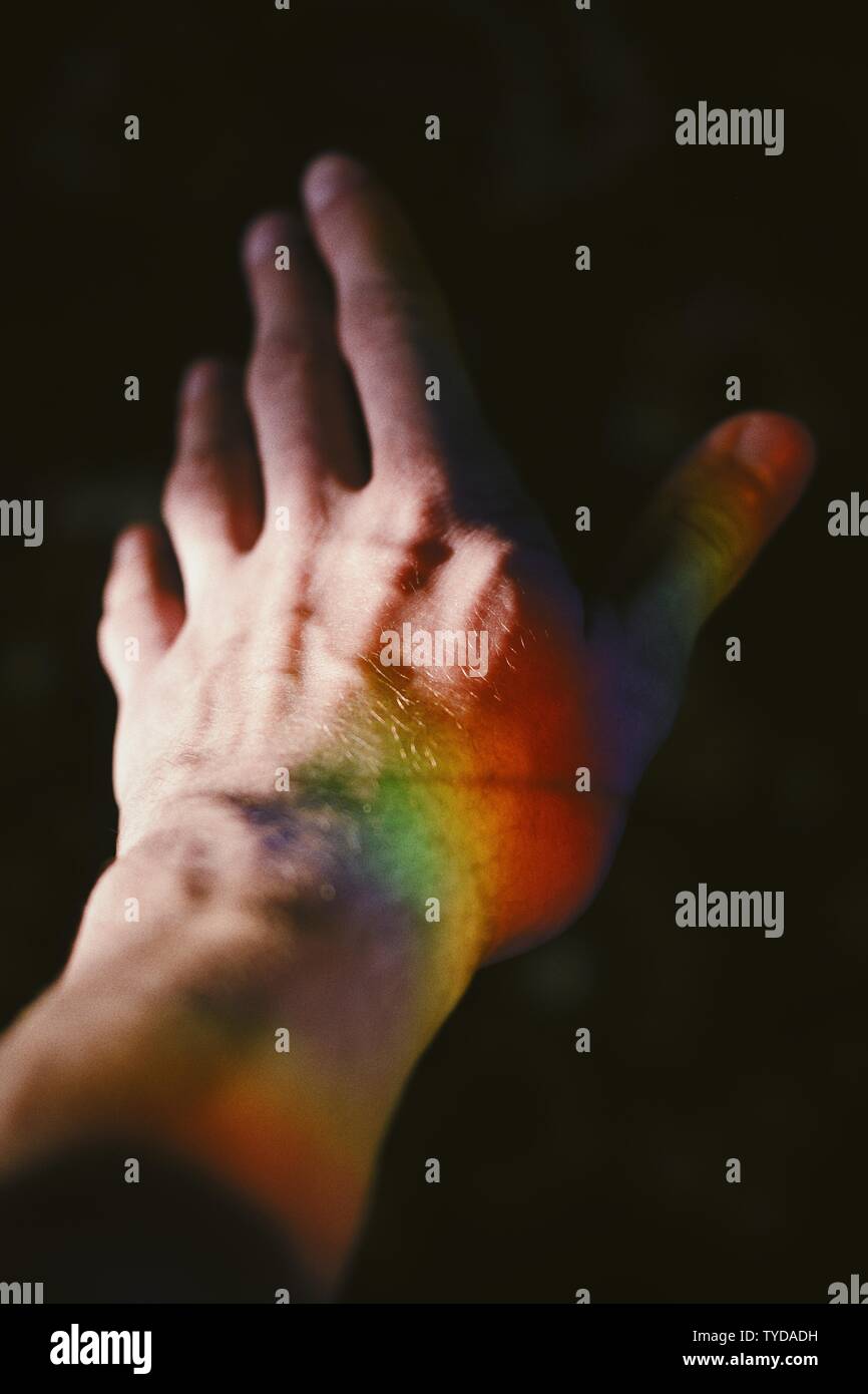 rainbow with black background on Hand Of A Male With A Rainbow Texture On The Side With A Pitch Black Background Stock Photo Alamy