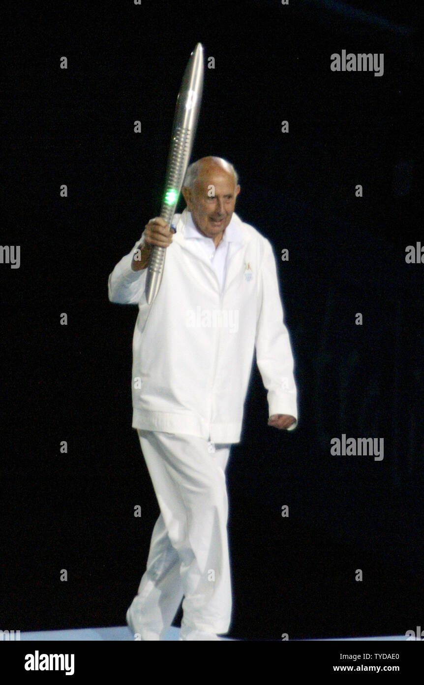 The final Queen's baton relay runner, John Landy, travels up the stairs of the Official Stand to present the baton to Her Majesty The Queen Elizabeth II at the Melbourne Cricket Grounds during the opening ceremonies of the XVIII Commonwealth Games on March 15, 2006. Landy, a former world record holder in the 1500 meter run and mile race, is the Governor of Victoria.   (UPI Photo/Grace Chiu). Stock Photo