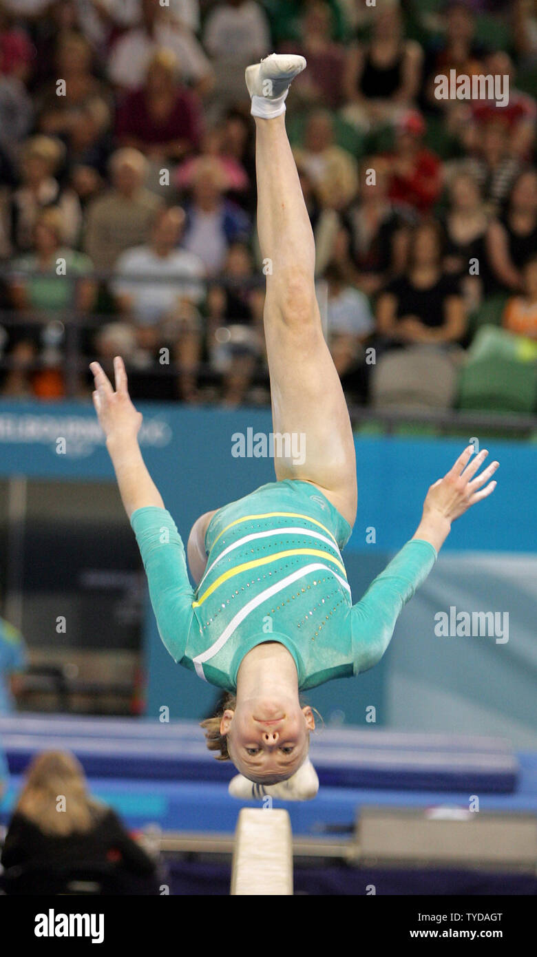 South African gymnast Francki Van Rooyen performs a forward aerial walkover on the balance beam in the women's team and qualifying competition at the XVIII Commonwealth Games in Melbourne on March 16, 2006. Van Rooyen stands in first place in the individual all around standings with 52.400 points, while the South African team leads with a total of 155.000 points after the first of two subdivisions. The artistic gymnasts are being scored for the first time using the new international scoring system.  (UPI Photo/Grace Chiu). Stock Photo