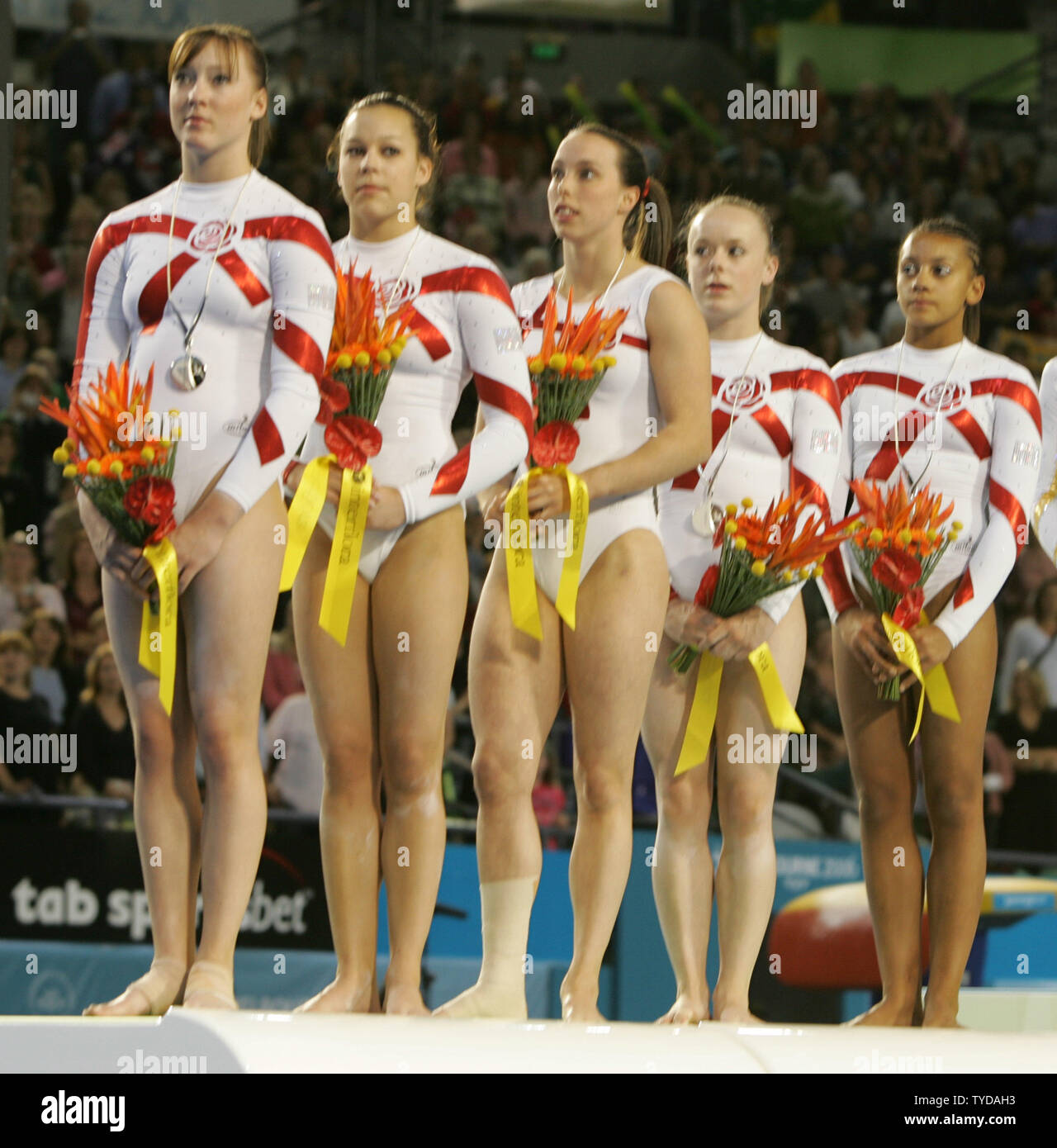 The women's artistic gymnastics team from England claim the silver medal in the women's team finals and qualifying competition at the XVIII Commonwealth Games in Melbourne on March 17, 2006. The English team of (from left) Imogen Cairns, Shavahn Church, Elizabeth Tweddle (injured), Hannah Clowes, and Becky Downie finished with a total of 164.350 points between Australia and Canada. The artistic gymnasts are being scored for the first time using the new international scoring system.  (UPI Photo/Grace Chiu). Stock Photo