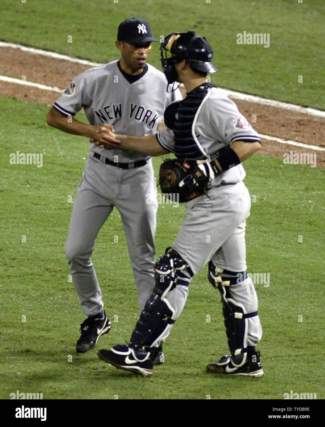 New York Yankees catcher Jorge Posada celebrates with Mariano Rivera after  they beat the Florida Marlins 6-1 in game 3 of the 2003 MLB World Series,  at Pro Player Stadium, Miami, Florida