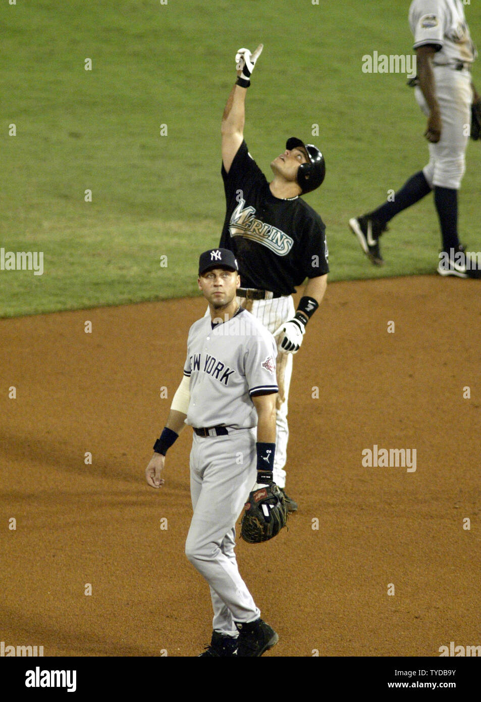 Florida Marlins catcher Ivan Pudge Rodriguez points to the sky, Yankees  Derek Jeter in foreground, after hitting a double against the New York  Yankees in game 4 of the 2003 MLB World