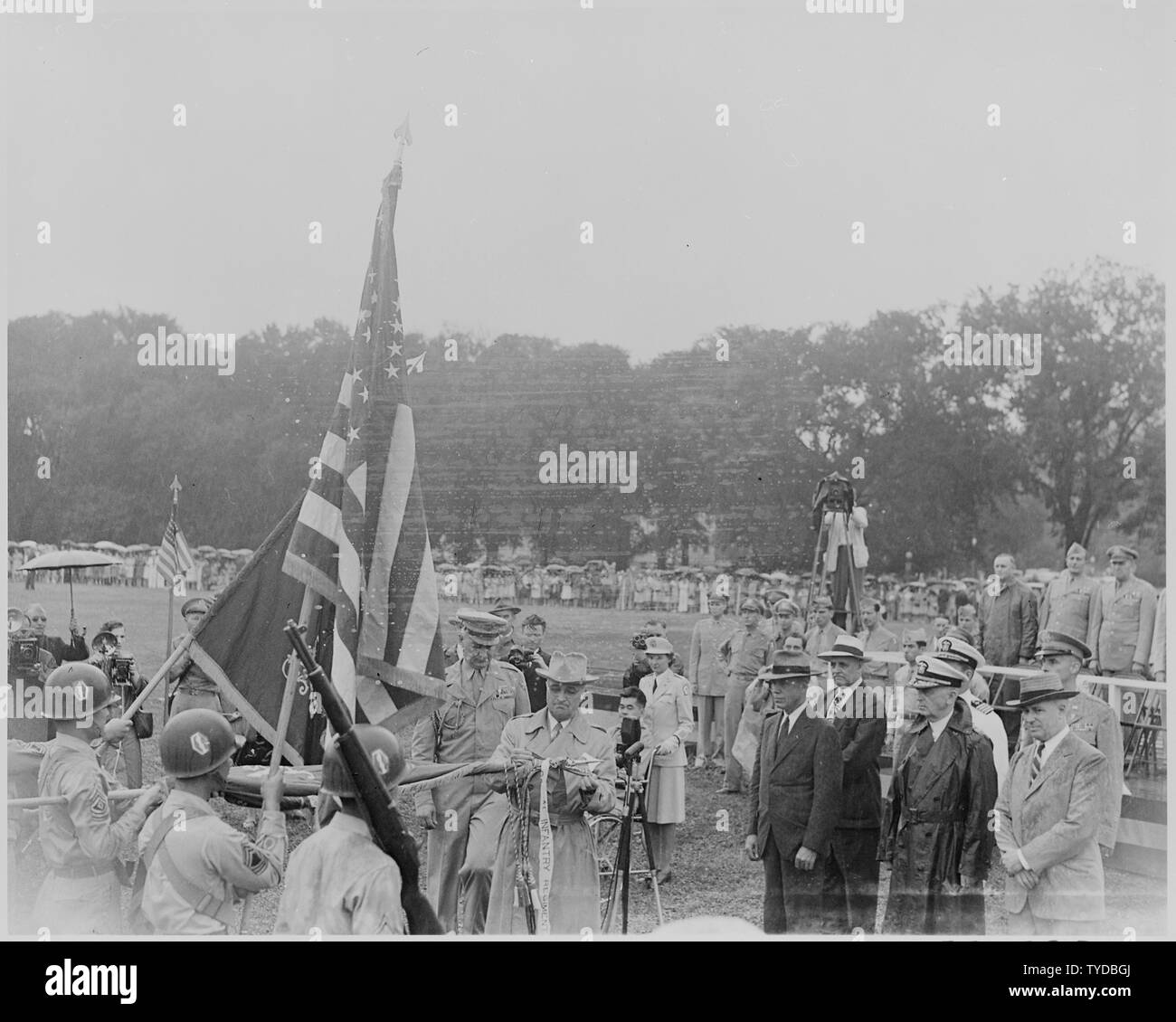 Photograph of President Truman decorating the colors of the Nisei 442nd Regimental Combat Team, as other dignitaries look on. Stock Photo