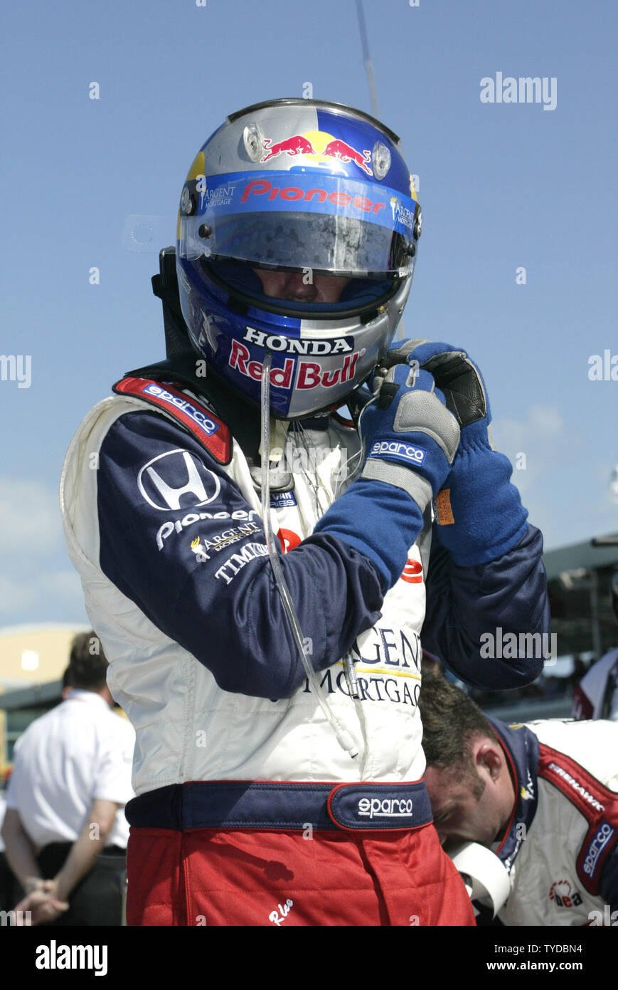 Alex Barron prepares to enter his car prior to the running of the IRL ...