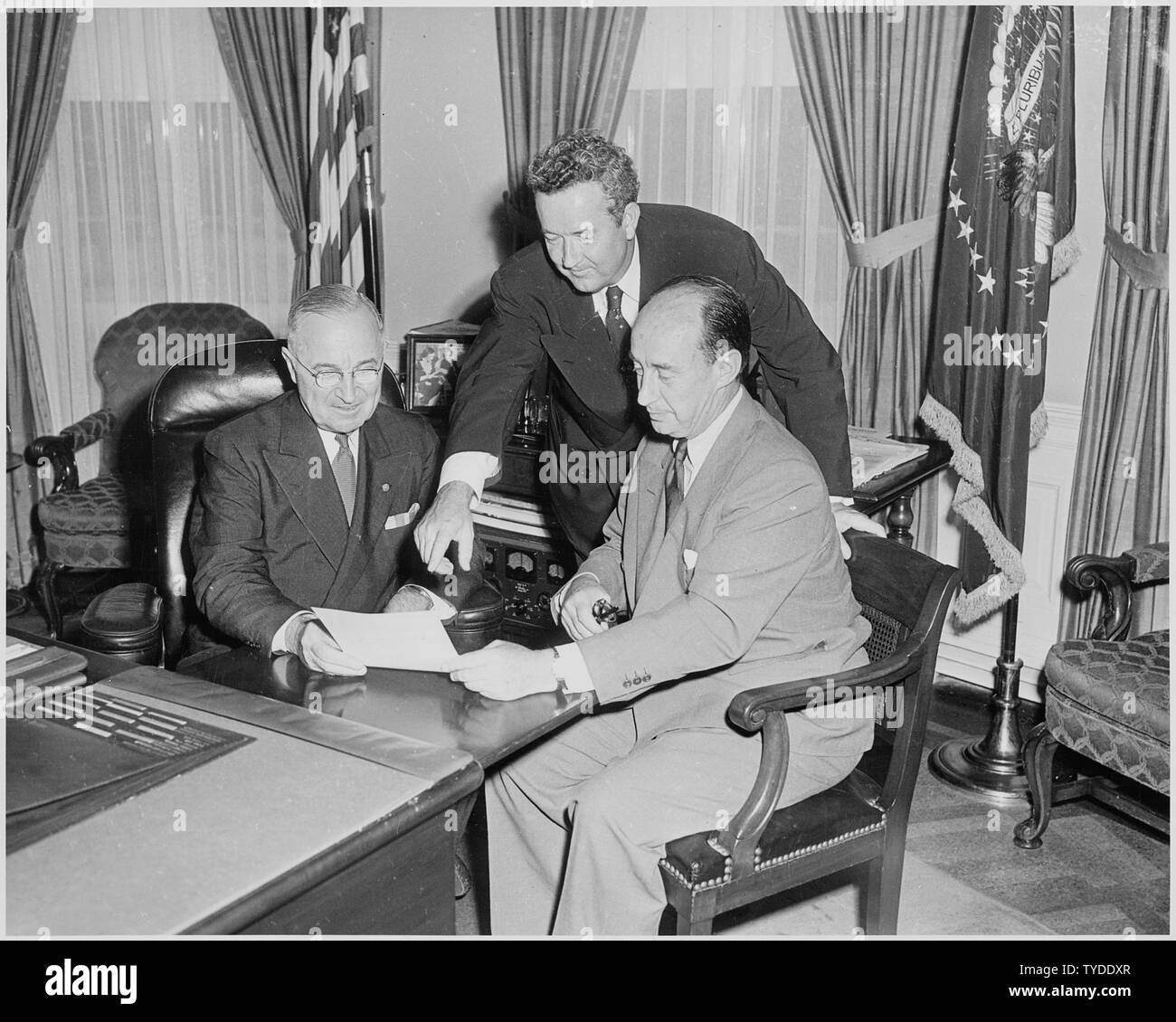 Photograph of President Truman in the Oval Office with the Democratic
