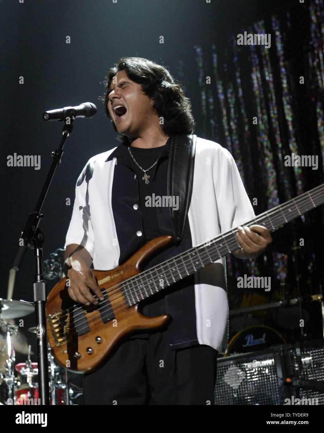 JoJo, bass guitar player for the Grammy Award winning Rock-N-Roll trio Los  Lonely Boys, grimaces as he plays during a music concert featuring the  Texas based band, at Contingency Operating Base Speicher