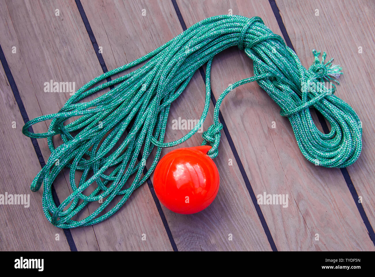 tackle to facilitate the supply of the mooring cable to the shore. A coil  of thin green rope with a plastic red ball on the end Stock Photo - Alamy