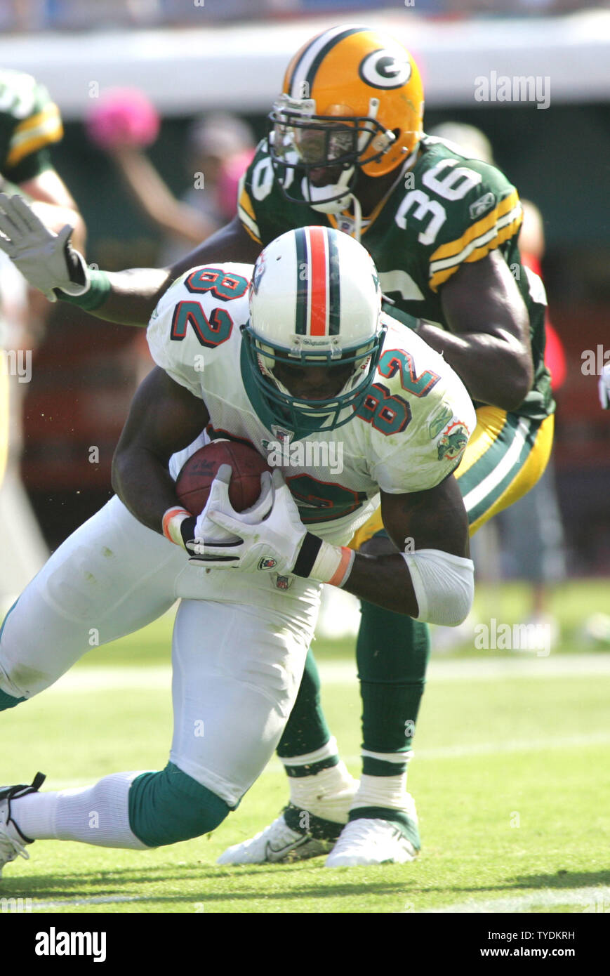 Miami Dolphins receiver Derek Hagan is tackled by Baltimore Ravens  cornerback Willie Gaston after a short gain in second half action at Dolphin  Stadium in Miami on December 16, 2007. The Dolphins