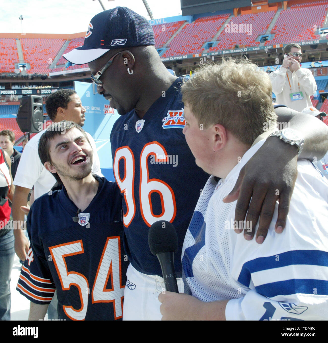 American Idol auditioners Kenneth Briggs (L) and Jonathan Jayne (R) speak  with Chicago Bears defensive end Alex Brown at Media Day for Super Bowl XLI  at Dolphins Stadium in Miami on January