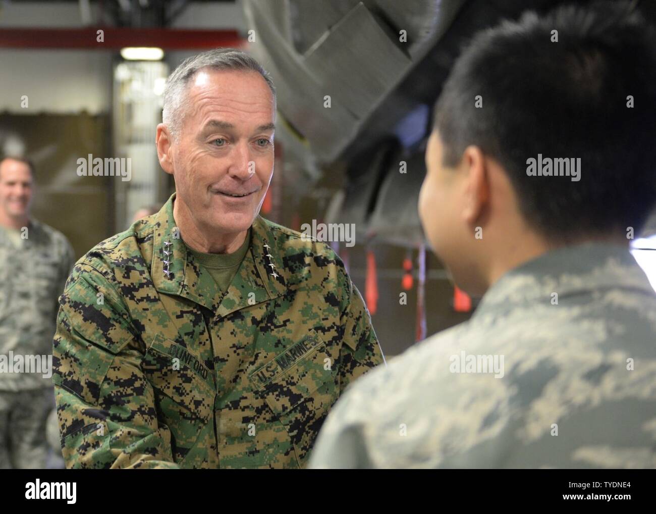 U.S. Marine Corps Gen. Joseph F. Dunford Jr., chairman of the Joint Chiefs of Staff, commends an Airman at Minot Air Force Base, N.D., Nov. 2, 2016. Dunford received a tour of the weapons storage area, as well as, a tour of a B-52H Stratofortress static. Stock Photo