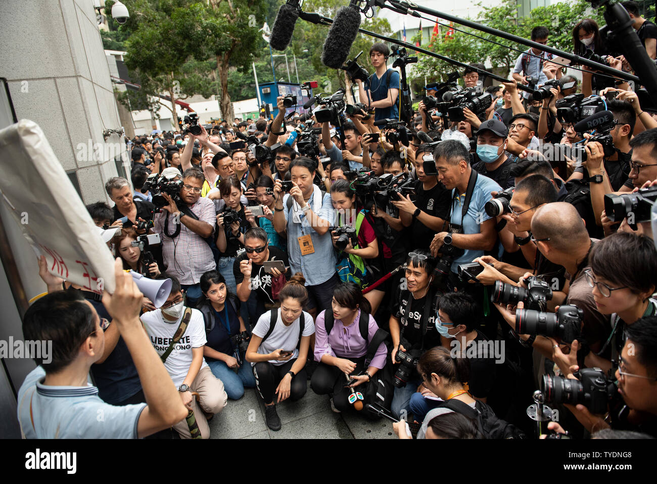 Protesters and press gather outside the British Consulate General during the demonstration.Activists protest against the extradition bill rallied to different nation’s embassies and consulates to raise the issue with Chinese President Xi Jinping at this week's G-20 summit in Japan. Stock Photo