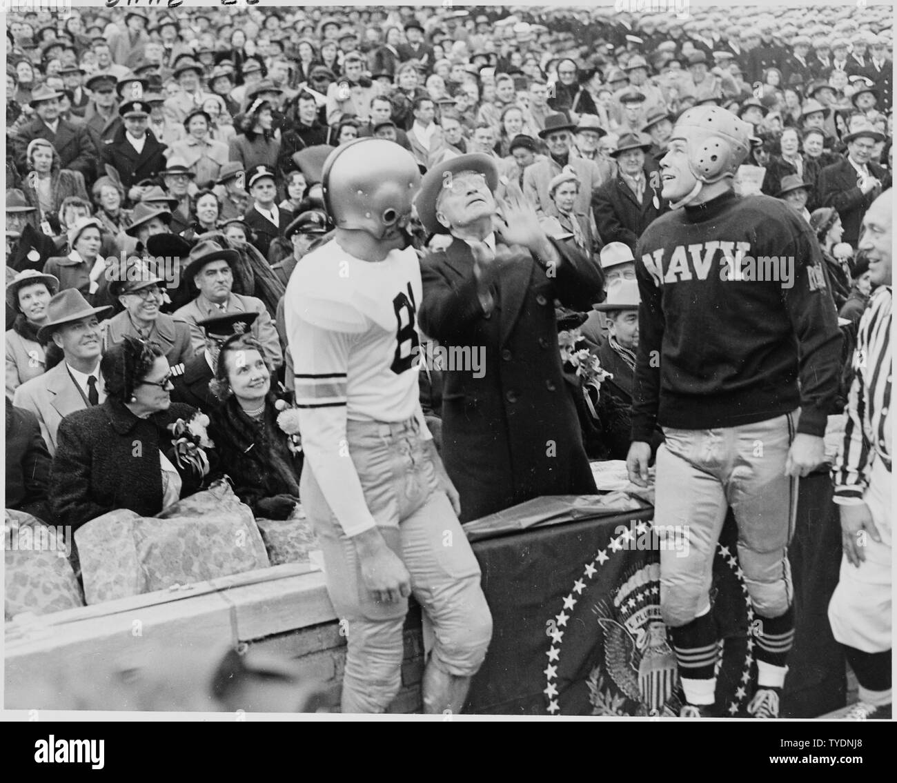Photograph of President Truman tossing a coin in the air before the