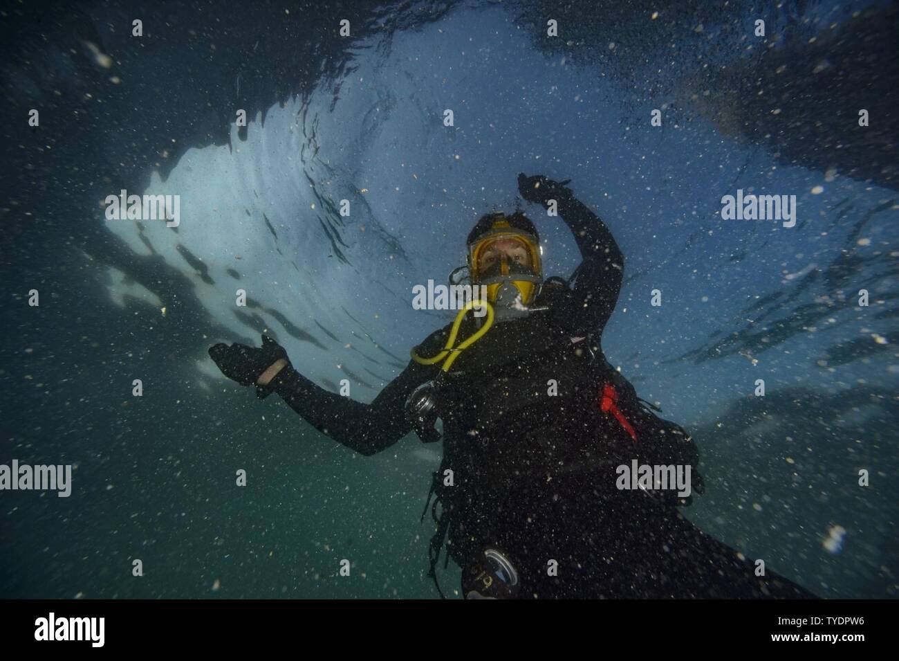 Petty Officer 2nd Class David Savell, assigned to Commander, Task Group (CTG) 56.1, takes part in an Anti-Terrorism Force Protection dive off the coast of Bahrain, Nov. 5th, 2016. CTG -56.1 conducts mine countermeasures, explosive ordnance disposal, salvage-diving and force protection operations throughout the U.S. 5th Fleet area of operations. Stock Photo