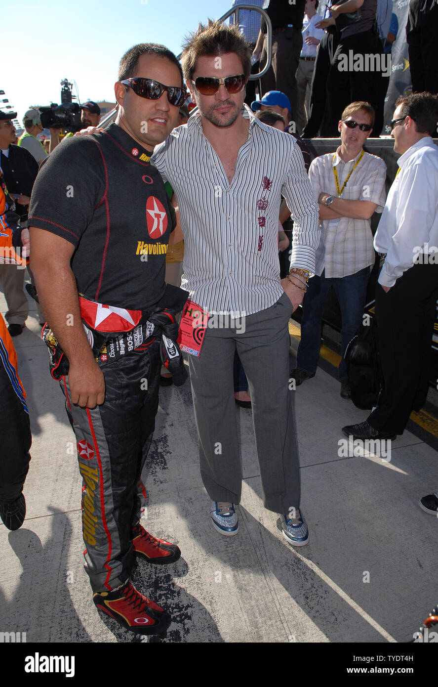 Colombian musician Juanes visits fellow countryman Juan Pablo Montoya (L) prior to the start of the NASCAR Nextel Cup Ford 400 at Homestead-Miami Speedway in Homestead, Florida on November 18, 2007.   (UPI Photo/Jeff Daly) Stock Photo