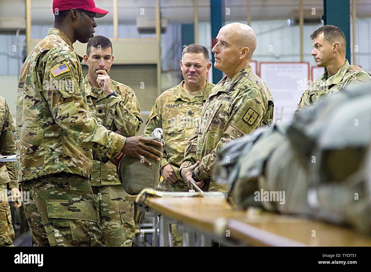 Then-Brig. Gen. Rodney Fogg – when serving as the 54th Quartermaster General Commandant – is briefed by Warrant Officer Joshua Hendrax, air drop systems technician, 11th Quartermaster Company, 189th Combat Sustainment Support Battalion, about the reserve parachutes during a visit with leaders from the 82nd Airborne Division Sustainment Brigade to Fort Bragg, N.C., in 2016. Fogg inquired how the challenges each location endures could be addressed to improve Paratrooper and equipment readiness and some new obstacles they may encounter as they continue operations. Stock Photo