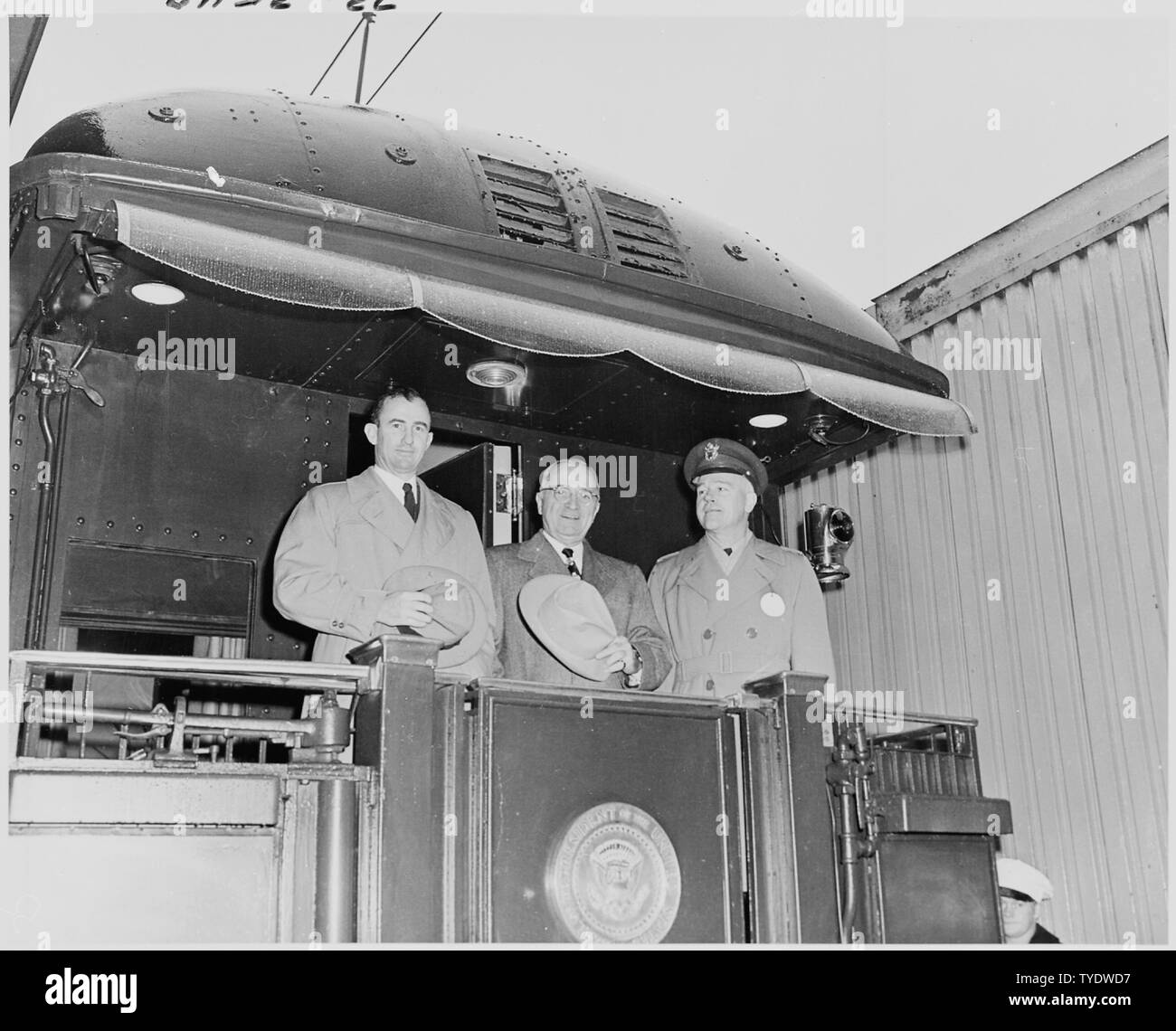 Photograph of President Truman with two other dignitaries on the rear