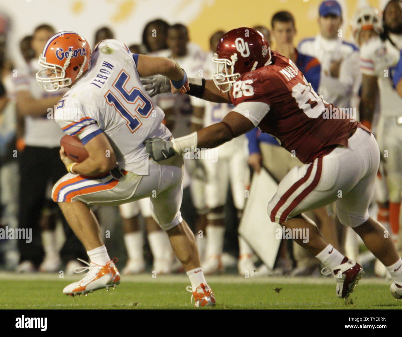 Florida quarterback Tim Tebow spins out of the grasp of Oklahoma defensive end Adrian Taylor in the second quarter of the 2009 FedEx BCS National Championship NCAA football game in Miami on January 8, 2009.  (UPI Photo/Mark Wallheiser) Stock Photo