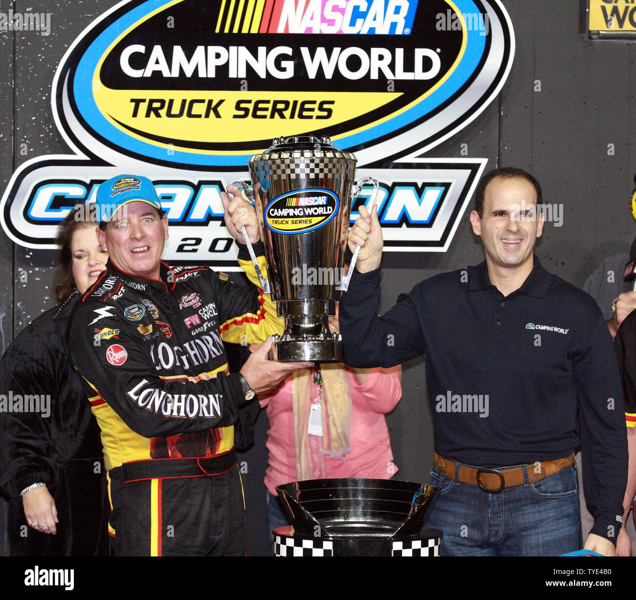 Camping World CEO Marcus Lemonis (R) presents Ron Hornaday Jr the