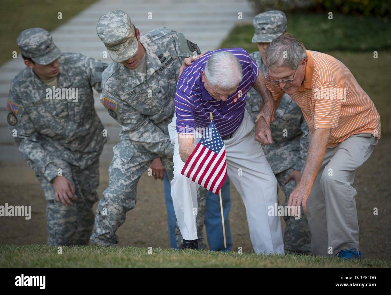 Retired U.S. Army Col. Ben Skardon, 99, a survivor of the Bataan Death March, gets help placing a flag on Otis Morgan’s stone on Clemson University’s Scroll of Honor, Nov. 3. 2016. Morgan was a fellow Clemson alum who helped save Skardon’s life while they were both interred in a Japanese prisoner of war camp. Morgan did not survive the war. Stock Photo