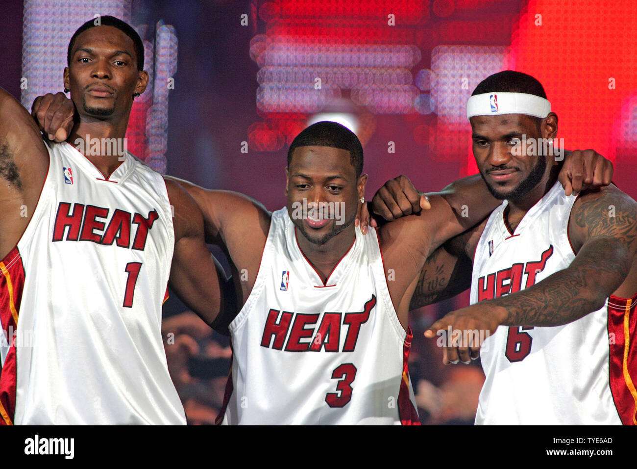 Chris Bosh (L), Dwyane Wade (C) and LeBron James show 10,000 fans their  Miami Heat jerseys after signing 6 year contracts with the Heat at the  American Airlines Arena in Miami on