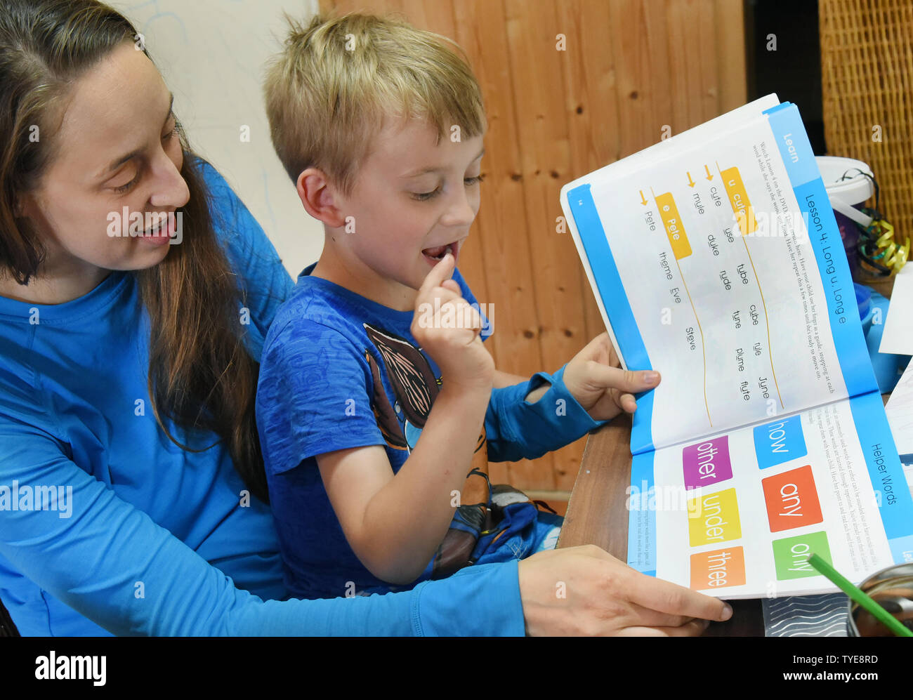 25 June 2019, Saxony, Schönwölkau: With five of her six children sitting Emma Fenchel, the mother of six children, learns English with her five-year-old son Matteo. The father, Stefan Fenchel and the Canadian moved from Bavaria to Leipzig in 2004 and now live in Schönwölkau with their six children, three girls and three boys between 12 and one year old. In the small village they have built an old house and enjoy the country life with their children. While at school in the neighboring city the German language is of course spoken, the whole family speaks English at home. (to dpa 'Where the child Stock Photo