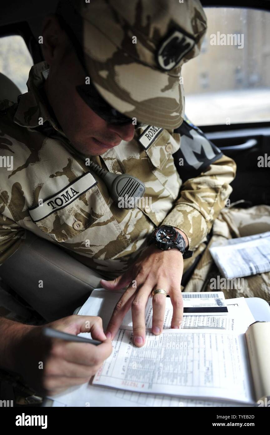 Cpl Caporal Marius Toma Writes A Traffic Citation For A Driver On Disney Drive On Bagram Airfield The Driver Made An Unsafe Act While Operating A Motor Vehicle The Tickets Serve As