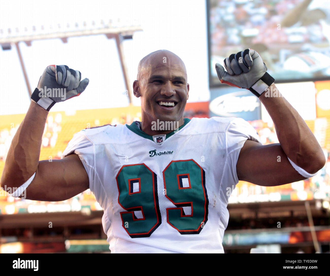 Miami Dolphins linebacker Jason Taylor (99) is escorted off the