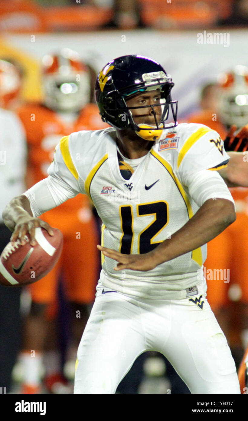 West Virginia quarterback Geno Smith passes during first half action