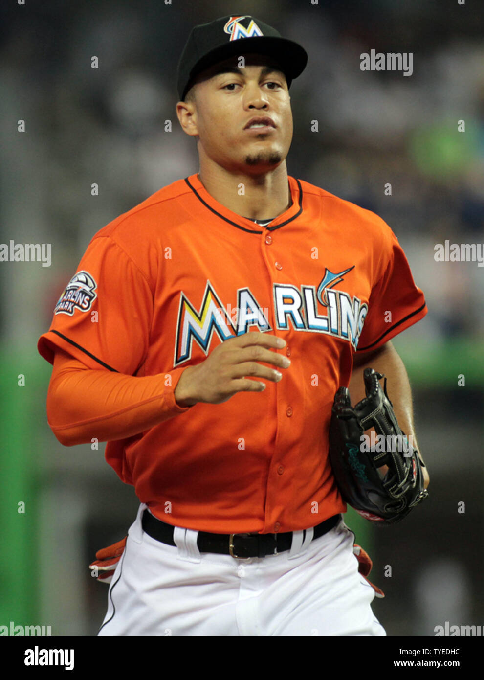Miami Marlins center fielder Giancarlo Stanton returns to the dugout after  the second inning against the New York Yankees in their first exhibition  game at the new Marlins Ball Park April 1