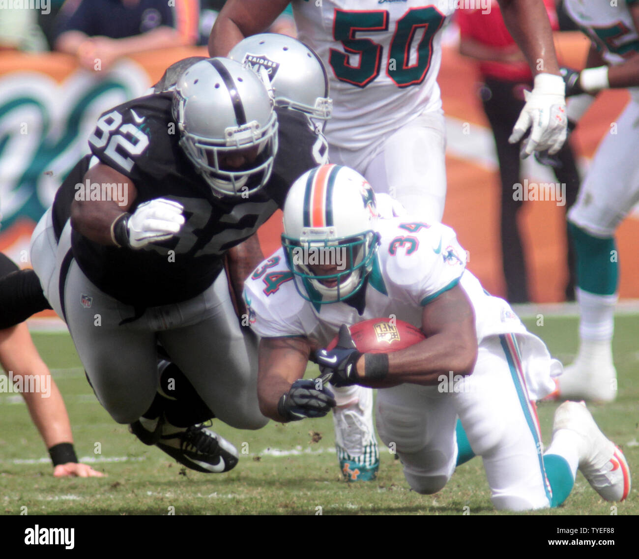 Miami Dolphins RB Marcus Thigpen (34) is tripped up against the Oakland Raiders at Sun Life Stadium September 16, 2012, in Miami, Florida. The Miami Dolphins beat the Oakland Raiders 35-13.                   UPI/Susan Knowles Stock Photo