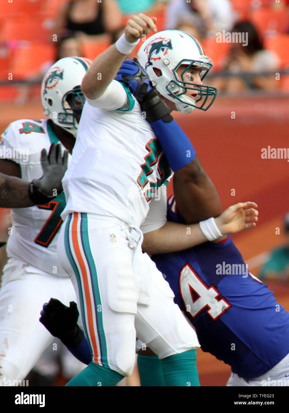 Buffalo Bills Defensive End Kyle Moore (54) draws a 15 yard penalty for  roughing the passer on Miami Dolphins Ryan Tannenhill during third quarter  action at Sun Life Stadium on December 23,