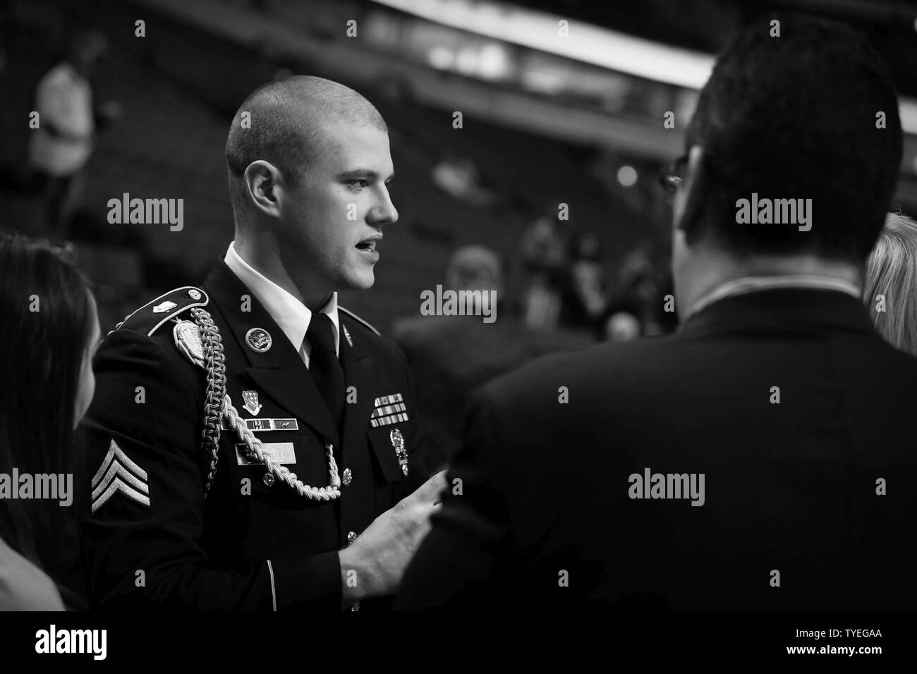The 2015 U.S. Army Soldier of the Year Sgt. Jared Tansley, Illinois native, speaks with Chicago Bulls staff members before the Chicago Bulls vs. New York Knicks game at the United Center, Nov. 4, 2016. Tansley attended the game as part of a home-town recognition here in Illinois. During his visit, Tansley spoke at numerous locations throughout Chicago and Illinois to include his former high school in Sycamore, Illinois. Stock Photo
