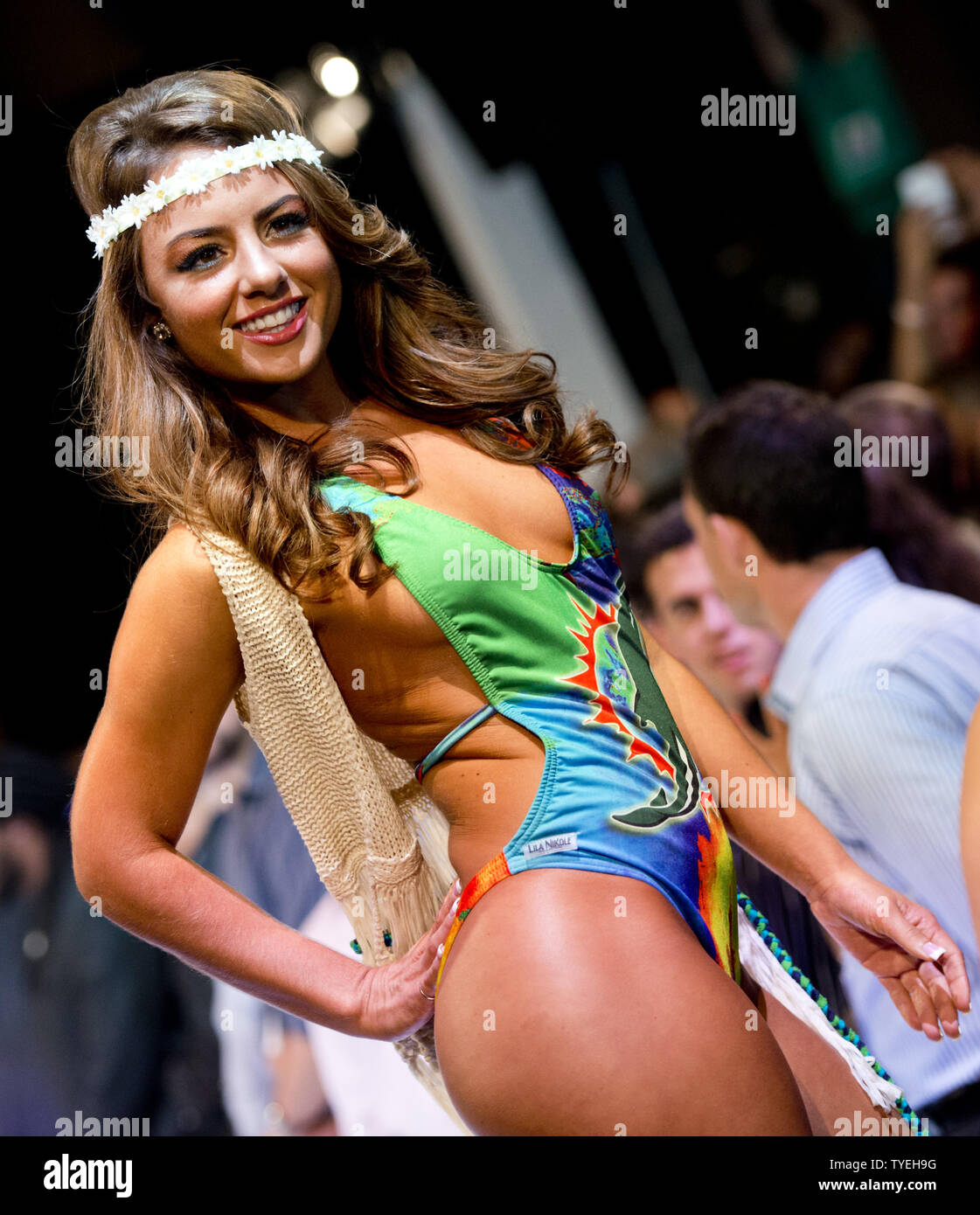 A Miami Dolphin cheerleader presents a swimsuit creation by Lila Nikole designer during the Miami Dolphins Cheerleaders 2014 Swimsuit Calendar Unveiling  at the  LIV Nightclub, Fontainebleau Hotel, Miami Beach, Florida, September 5, 2013. UPI/Gary I Rothstein. Stock Photo