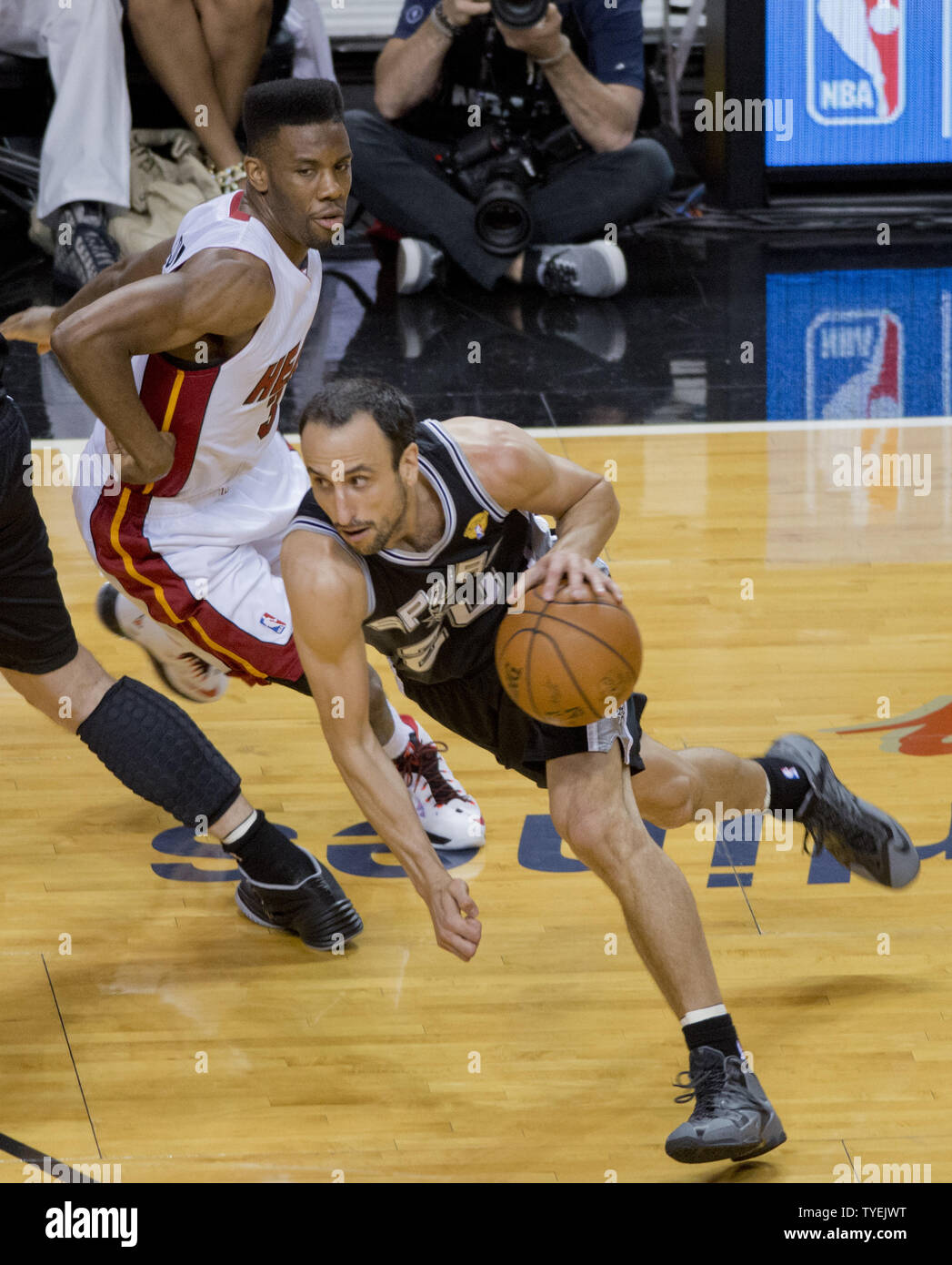 San Antonio Spurs Manu Ginobili (20) drives past  Miami Heat Norris Cole (30)  in game 4 of the NBA Finals at the American Airlines Arena, in Miami, June 12, 2014. The Spurs defeated the Heat 107-86 to take a 3-1 game lead in the best of seven games. UPI/Gary I Rothstein Stock Photo