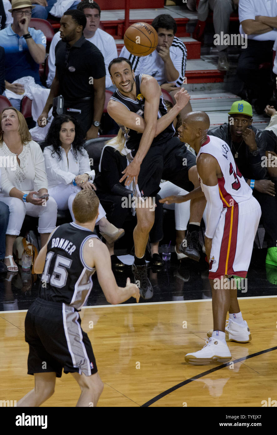 San Antonio Spurs Manu Ginobili (20) passes to Matt Bonner (15) as Miami Heat guard Ray Allen (34) looks on in game 4 of the NBA Finals at the American Airlines Arena, in Miami, June 12, 2014. The Spurs defeated the Heat 107-86 to take a 3-1 game lead in the best of seven games. UPI/Gary I Rothstein Stock Photo
