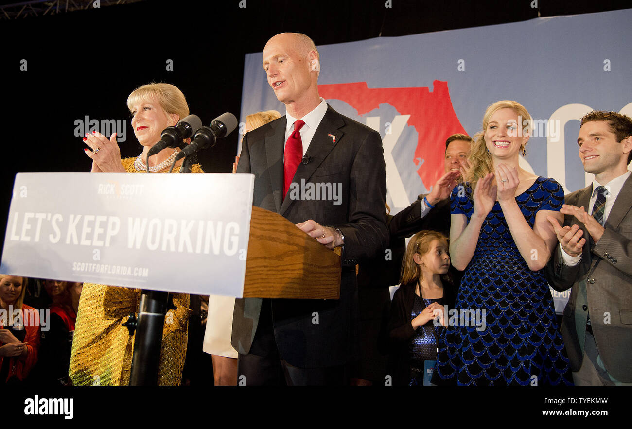 Florida Governor Rick Scott (R) and his wife Ann talk to supporters