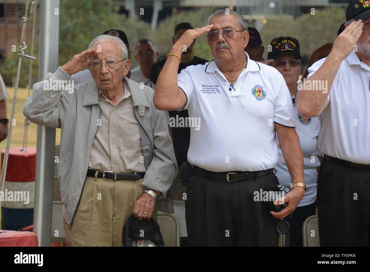 97-year-old World War II Veteran Louis Jimenez and his nephew Vietnam Veteran Enrique Flores salute the flag Nov. 4 during the Brooke Army Medical Center Veterans Day Celebration. Stock Photo