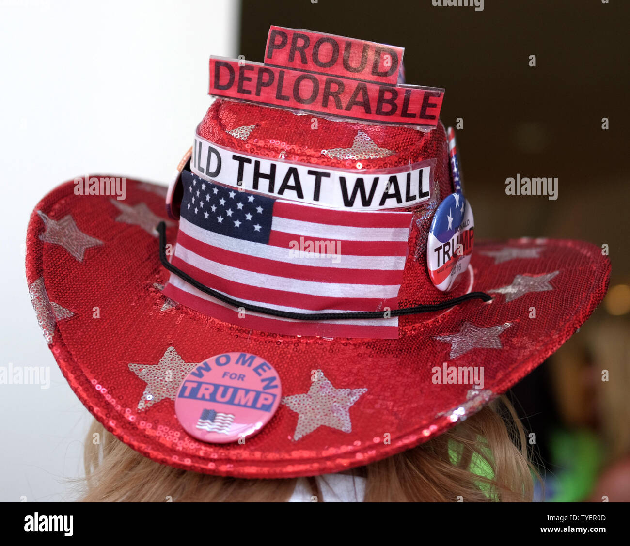 A supporter for Republican presidential nominee Donald Trump shows off ...