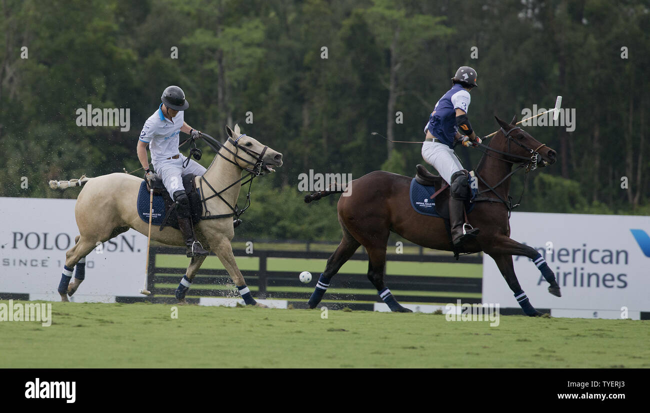 Britain's Prince Harry (L) strikes the ball defended by Nacho Figures from Argentina  tn the  2016  Sentebale Royal Salute Polo Cup at the Valiant Polo Farm  in Palm Beach, Florida on May 4, 2016. Photo by Gary I Rothstein/UPI Stock Photo