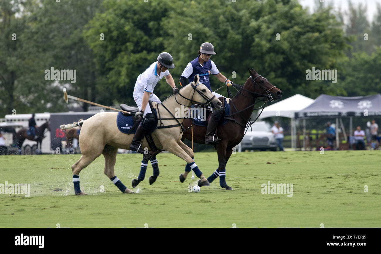 Britain's Prince Harry (L) strikes the ball defended by Nacho Figures from Argentina  in the  2016  Sentebale Royal Salute Polo Cup at the Valiant Polo Farm  in Palm Beach, Florida on May 4, 2016. Photo by Gary I Rothstein/UPI Stock Photo