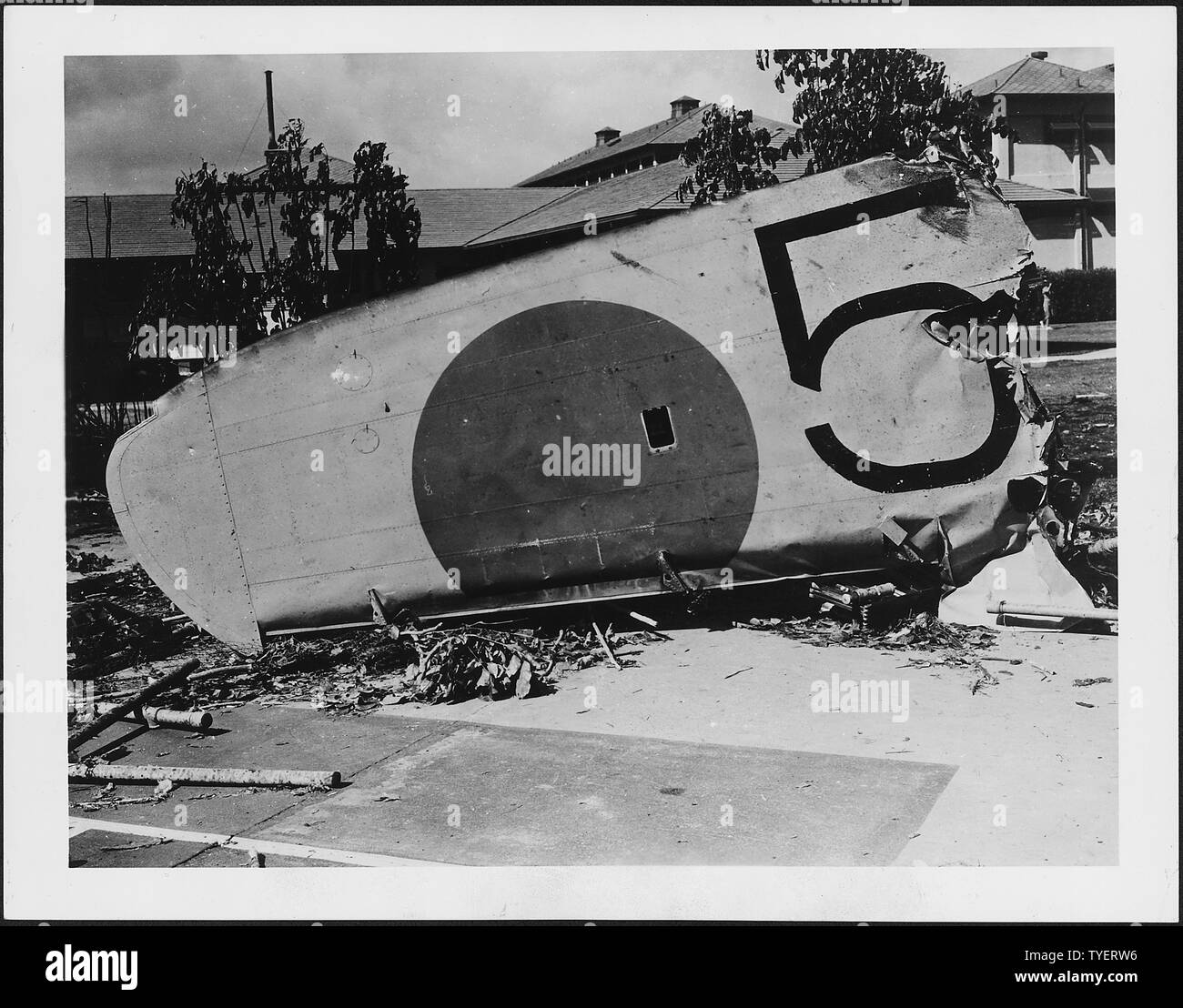 Photograph of a wing from a Japanese bomber shot down on the grounds of the Naval Hospital, Honolulu, Territory of Hawaii, during the attack on Pearl Harbor; General notes:  Wing of Japanese Nakajima B5N Type 97 torpedo bomber of from the aircraft carrier Kaga that crashed at Naval Hospital, Pearl Harbor, Hawaii, on 7 December 1941. The rising sun insignia later almost disappeared because of souvenir hunters. Stock Photo